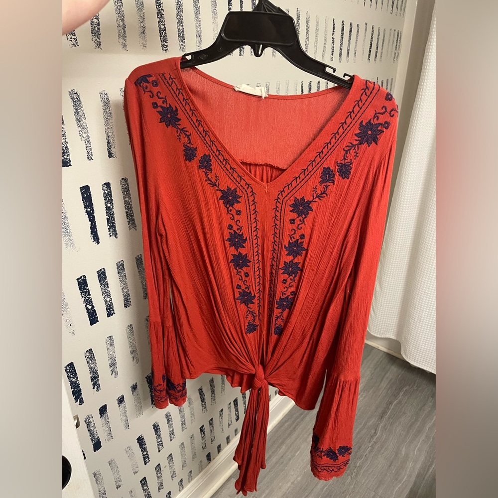 Burnt orange with navy embroidered detailing. Bell sleeves
